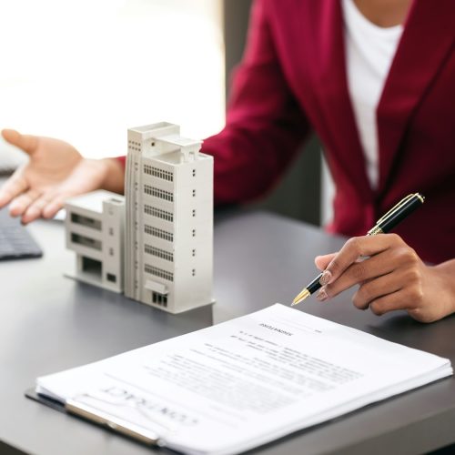 African american businesswoman in suit showing condominium model African american businesswoman in suit showing condominium model